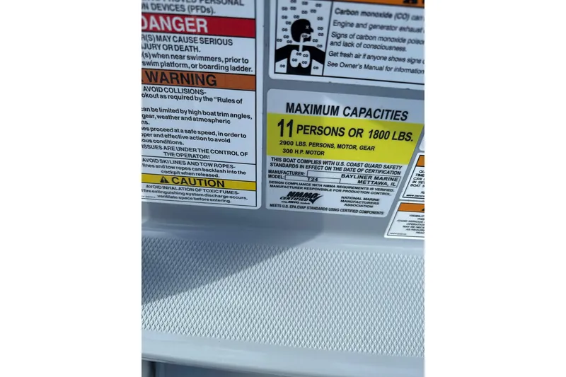 Slide: The Image of 2023 Trophy CC24 capacity label: 11 persons or 1800 lbs, safety warnings included. - 8