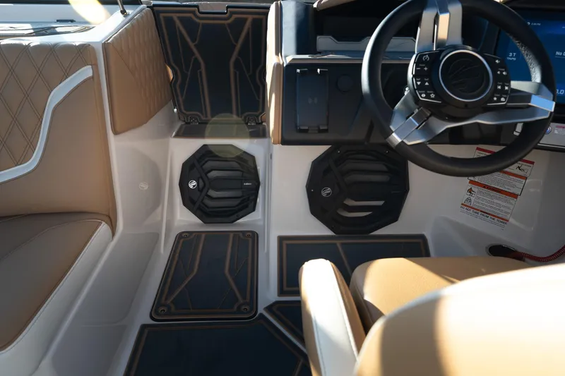 Slide: The Image of Interior of 2026 Tigé 24RZX boat featuring modern steering and speaker system. - 10