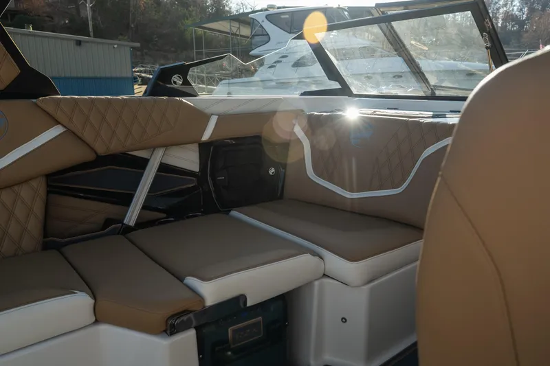 Slide: The Image of Luxurious interior of 2026 Tigé 24RZX boat with tan quilted seating. - 11