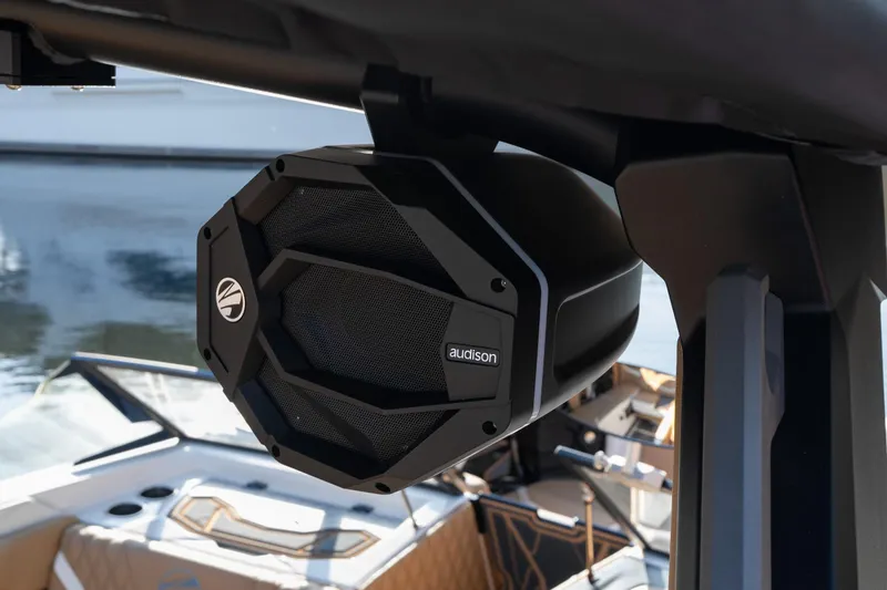 Slide: The Image of 2026 Tigé 24RZX boat with Audison speaker, luxurious interior, and water backdrop. - 23