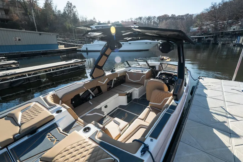 Slide: The Image of 2026 Tigé 24RZX boat with luxurious interior docked at a marina. - 24