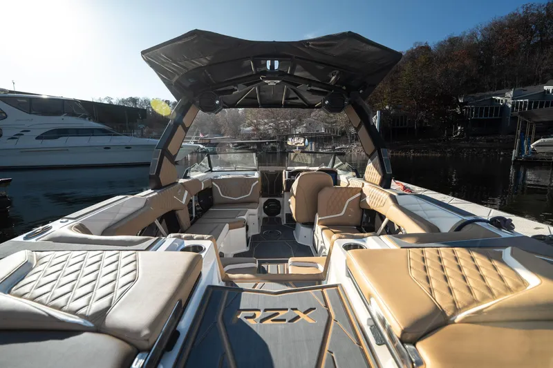 Slide: The Image of 2026 Tigé 24RZX luxury boat interior with tan seating, docked by the water. - 5