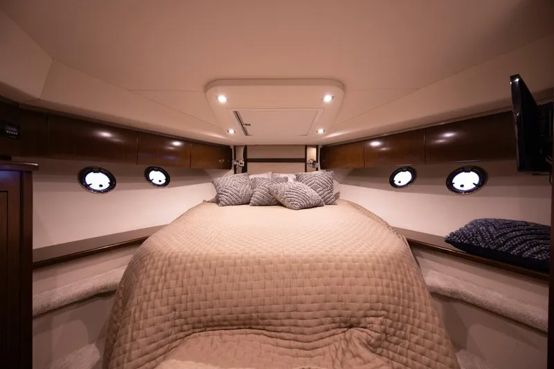 Slide: The Image of Luxurious cabin interior of 2013 Cruisers Yachts 540 Sports Coupe with cozy bedding. - 11