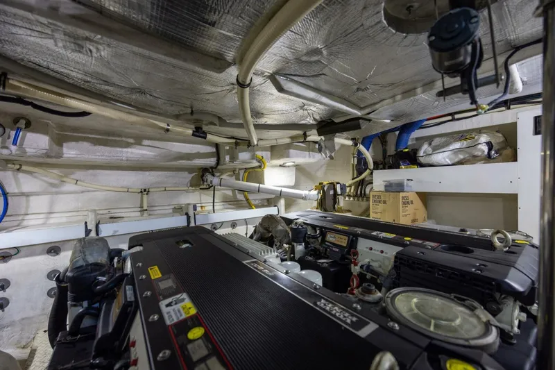 Slide: The Image of Engine room of 2013 Cruisers Yachts 540 Sports Coupe with visible machinery and piping. - 26