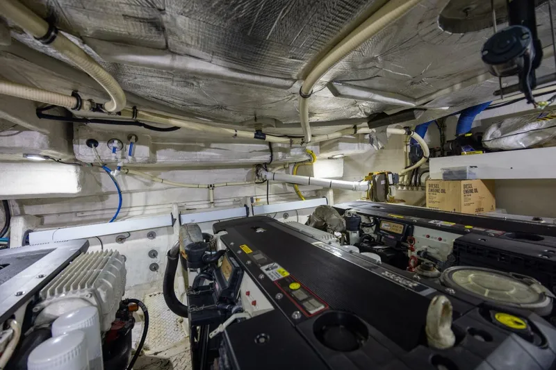 Slide: The Image of Engine room of 2013 Cruisers Yachts 540 Sports Coupe with visible machinery and piping. - 29