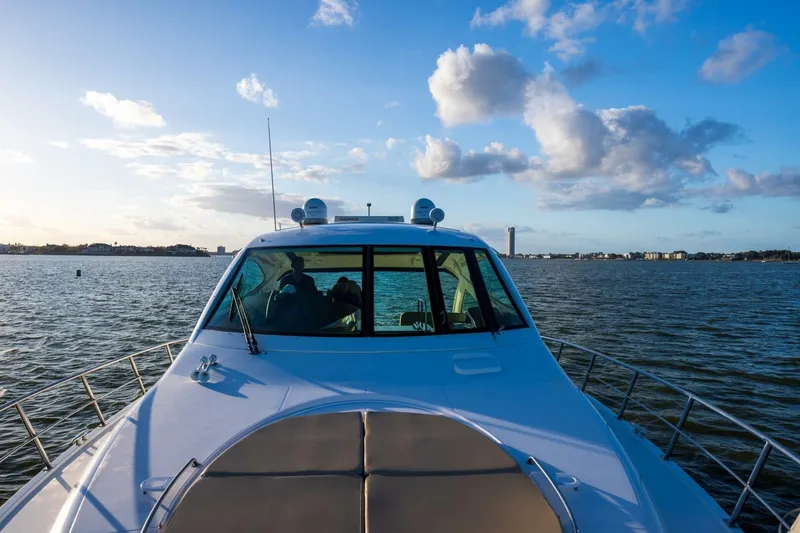 Slide: The Image of 2013 Cruisers Yachts 540 Sports Coupe on serene water under blue sky. - 40