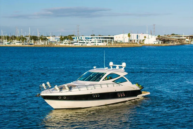 Slide: The Image of 2013 Cruisers Yachts 540 Sports Coupe on blue water near marina. - 48