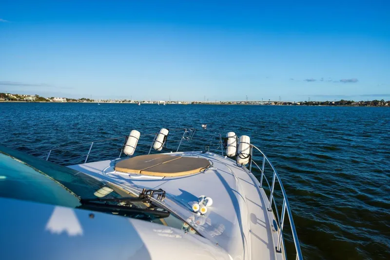 Slide: The Image of 2013 Cruisers Yachts 540 Sports Coupe on serene blue waters under clear sky. - 38