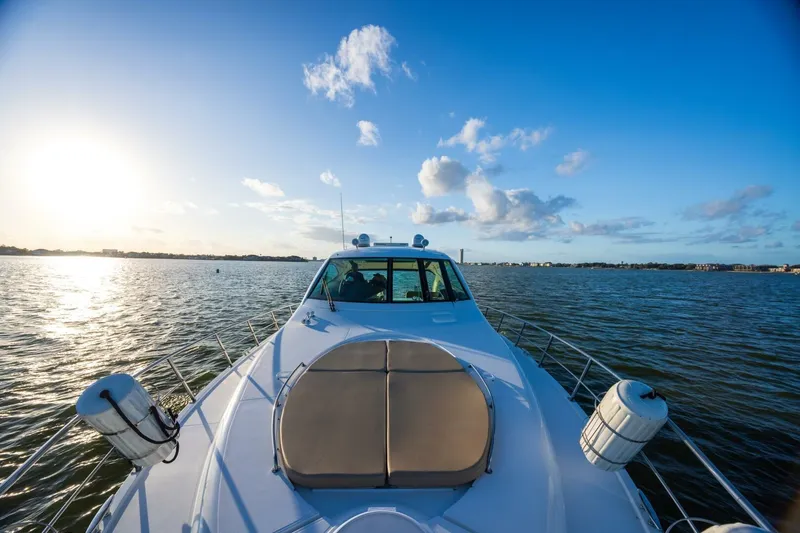 Slide: The Image of 2013 Cruisers Yachts 540 Sports Coupe on serene water at sunset. - 39