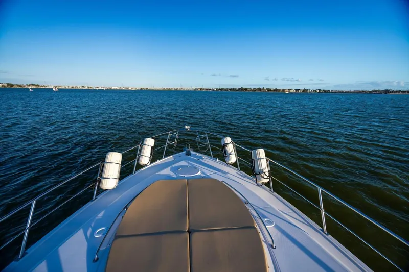 Slide: The Image of 2013 Cruisers Yachts 540 Sports Coupe on open water, clear blue sky. - 41
