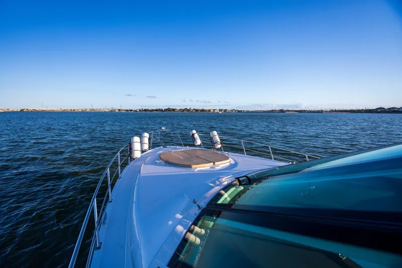 Slide: The Image of 2013 Cruisers Yachts 540 Sports Coupe on open water under clear blue sky. - 43