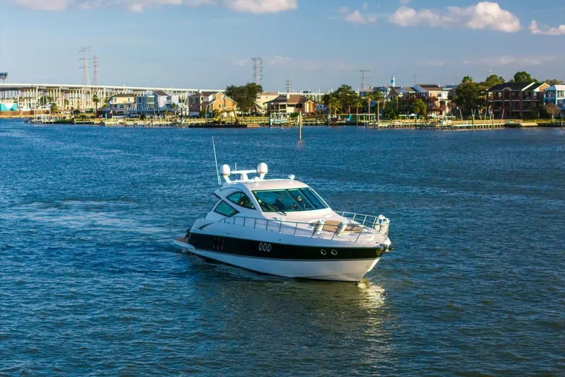 Slide: The Image of 2013 Cruisers Yachts 540 Sports Coupe on a scenic waterway. - 44