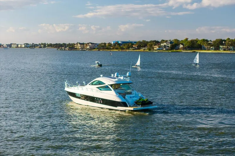 Slide: The Image of 2013 Cruisers Yachts 540 Sports Coupe on a scenic lake with sailboats. - 47