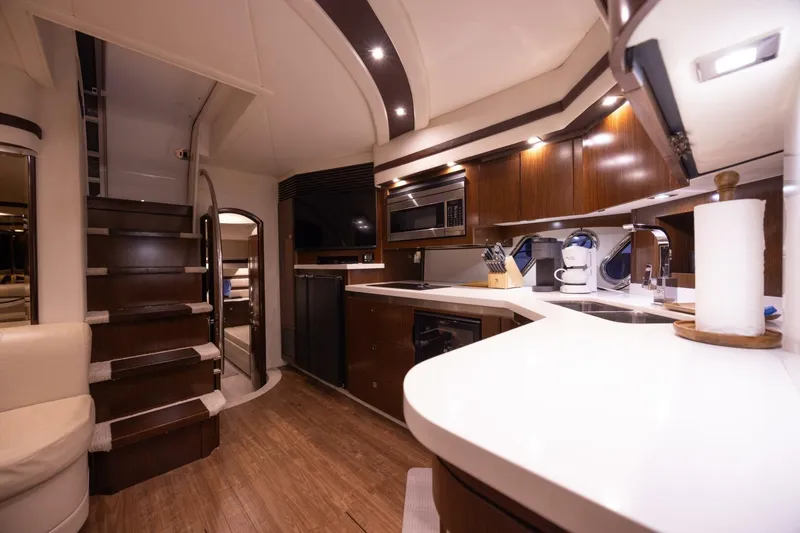 Slide: The Image of Luxurious interior of 2013 Cruisers Yachts 540 Sports Coupe with modern kitchen and staircase. - 9