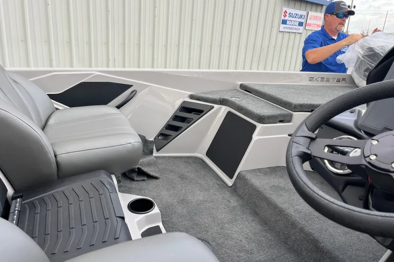 Slide: The Image of 2026 Skeeter ZXR21 SE boat interior with gray seating and steering wheel. - 10