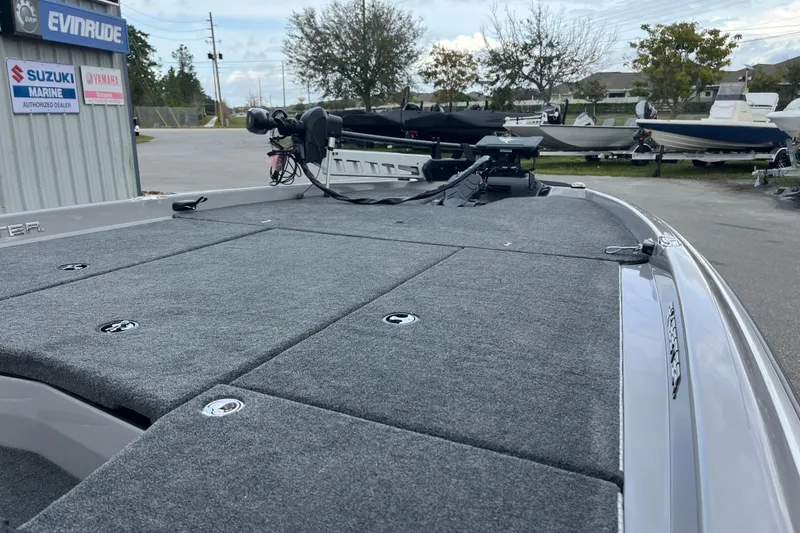 Slide: The Image of 2026 Skeeter ZXR21 SE boat deck with carpeted surface and trolling motor. - 6