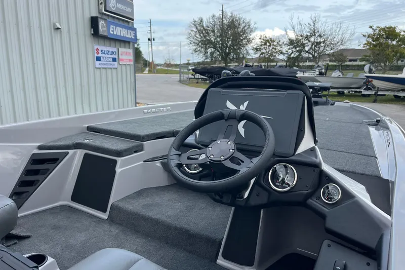Slide: The Image of 2026 Skeeter ZXR21 SE boat interior with steering wheel and dashboard controls. - 7