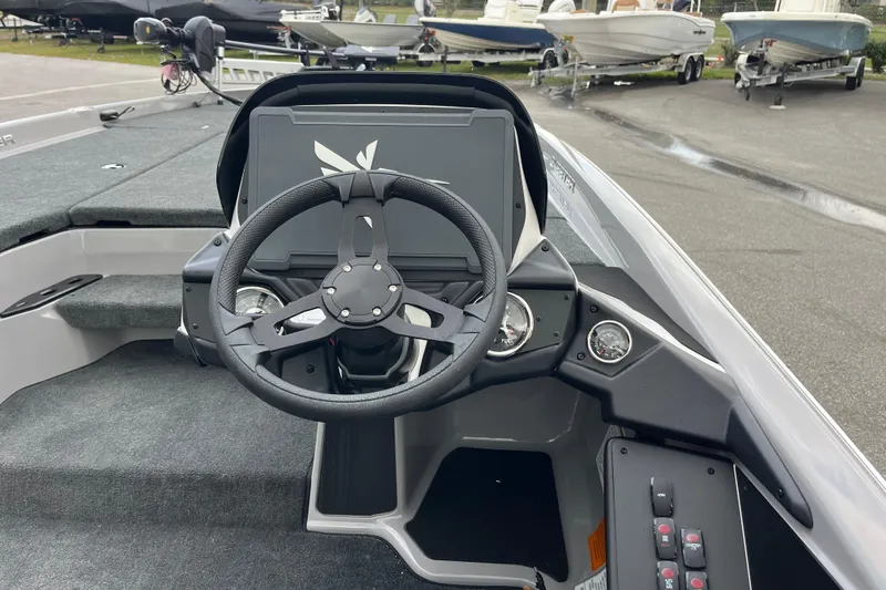 Slide: The Image of Steering console of 2026 Skeeter ZXR21 SE boat, featuring modern controls and dashboard. - 8