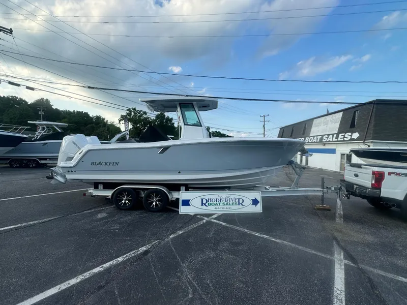 Slide: The Image of 2026 Blackfin 252 CC boat on trailer at dealership parking lot. - 3