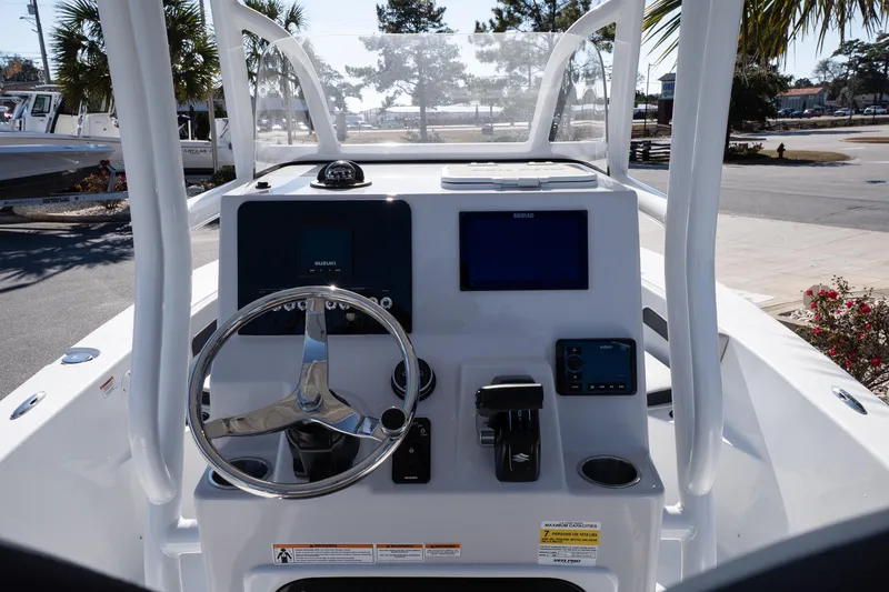 Slide: The Image of 2026 Sea Pro 202 Center Console boat dashboard with steering wheel and navigation controls. - 10