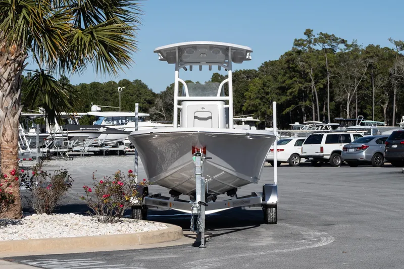 Slide: The Image of 2026 Sea Pro 202 Center Console boat on trailer in parking lot, surrounded by trees and cars. - 3