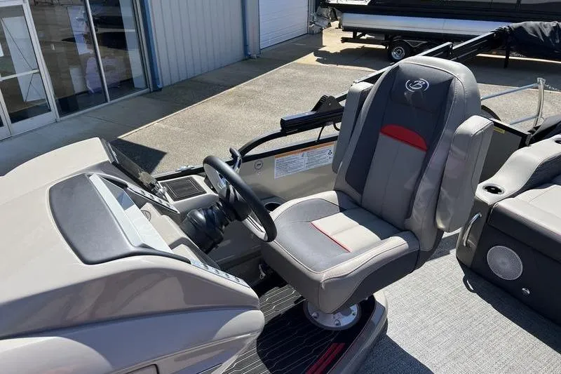 Slide: The Image of 2024 Barletta Corsa 23U boat interior with captain's chair and steering console. - 10
