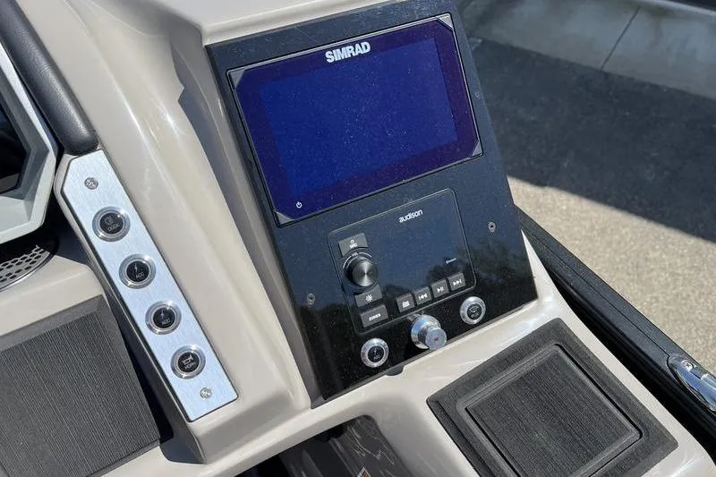 Slide: The Image of 2024 Barletta Corsa 23U dashboard featuring Simrad display and control panel. - 14