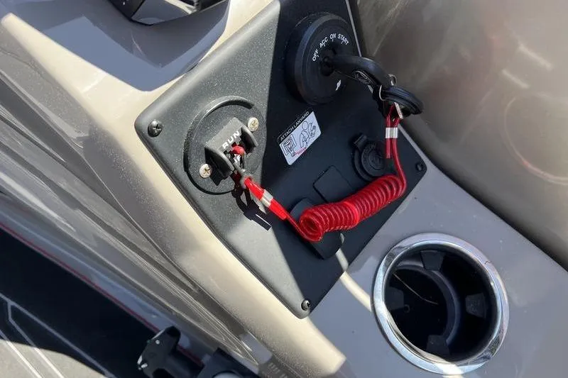 Slide: The Image of 2024 Barletta Corsa 23U boat dashboard with ignition switch and safety lanyard. - 16