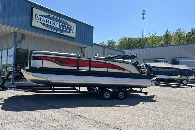 Slide: The Image of 2024 Barletta Corsa 23U pontoon boat on trailer at Marine Sales dealership. - 2