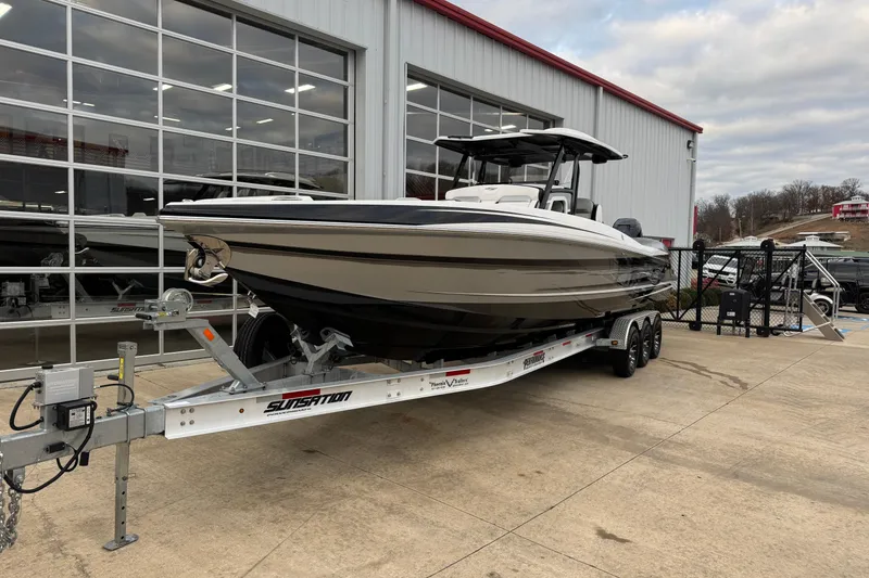 Slide: The Image of 2023 Sunsation 32CCX boat on trailer outside a showroom. - 1