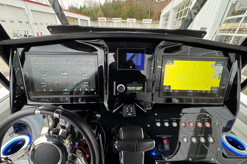 Slide: The Image of 2023 Sunsation 32CCX boat dashboard with dual Garmin displays and control panel. - 12
