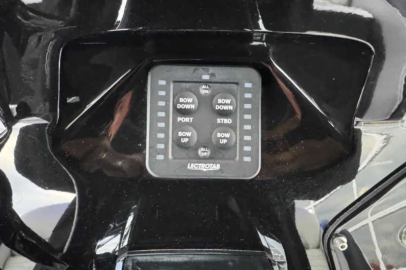 Slide: The Image of Control panel of 2023 Sunsation 32CCX boat with Lectrotab trim tab switches. - 14