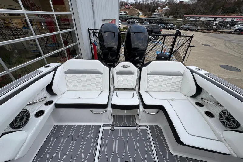 Slide: The Image of 2023 Sunsation 32CCX boat interior with white seating and dual outboard motors. - 18
