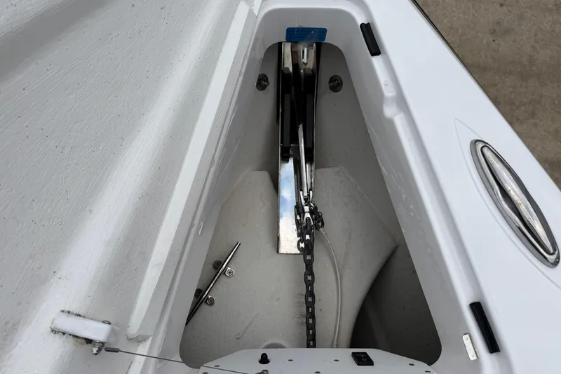 Slide: The Image of Anchor compartment of 2023 Sunsation 32CCX boat, featuring chain and stainless steel fittings. - 7