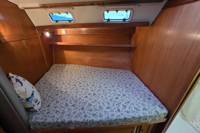 Slide: The Image of Cozy cabin interior of 1998 Catalina 42 MkII sailboat with wooden finish and floral bedding. - 10