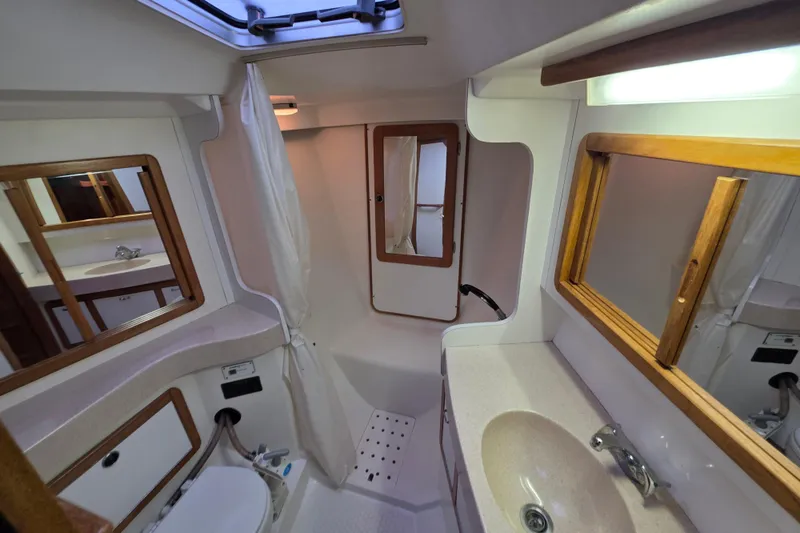 Slide: The Image of Bathroom interior of a 1998 Catalina 42 MkII yacht, featuring sink and shower. - 11