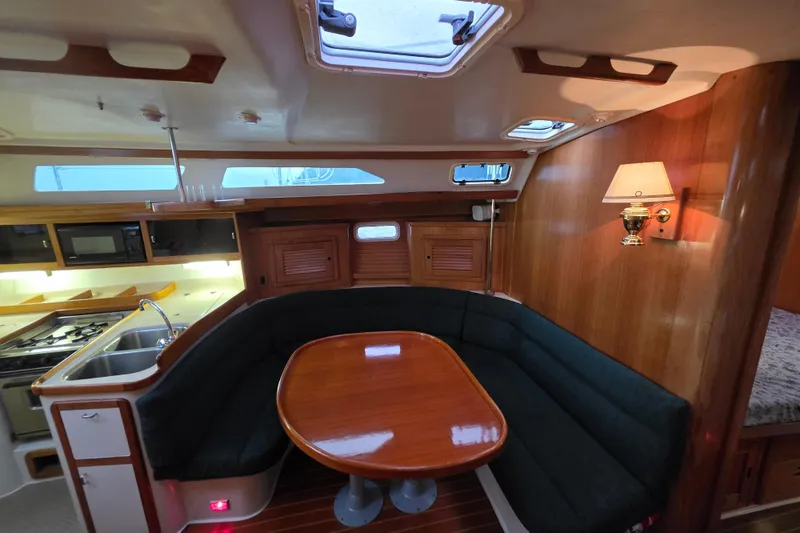 Slide: The Image of Interior of 1998 Catalina 42 MkII yacht with cozy dining area and kitchen. - 16