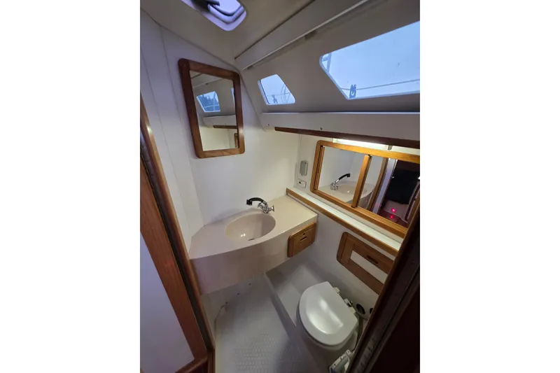 Slide: The Image of 1998 Catalina 42 MkII yacht bathroom with sink, mirror, and toilet. - 17