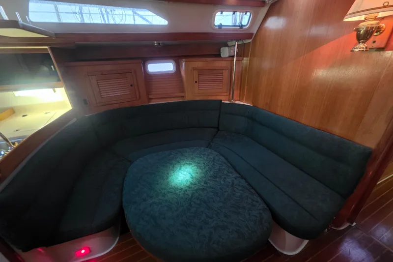 Slide: The Image of Cozy interior of 1998 Catalina 42 MkII sailboat with plush seating and wooden accents. - 18