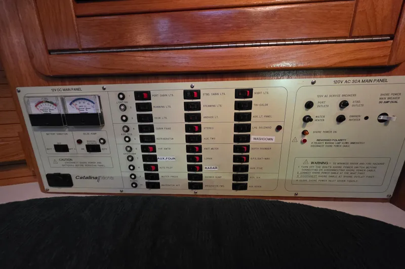Slide: The Image of Electrical control panel of a 1998 Catalina 42 MkII yacht, featuring various switches and gauges. - 20