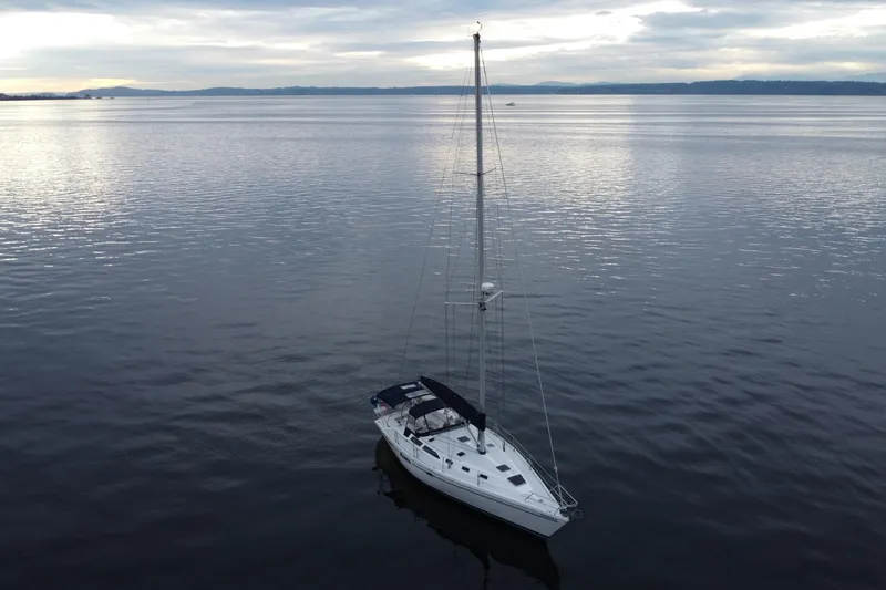 Slide: The Image of Sailboat Catalina 42 MkII 1998 on calm water under cloudy sky. - 21