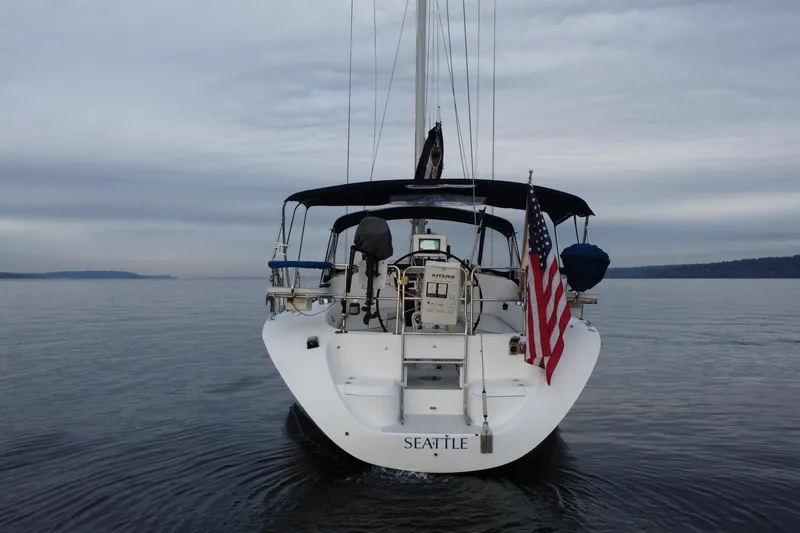 Slide: The Image of Sailboat Catalina 42 MkII 1998 on calm water, American flag, overcast sky. - 22