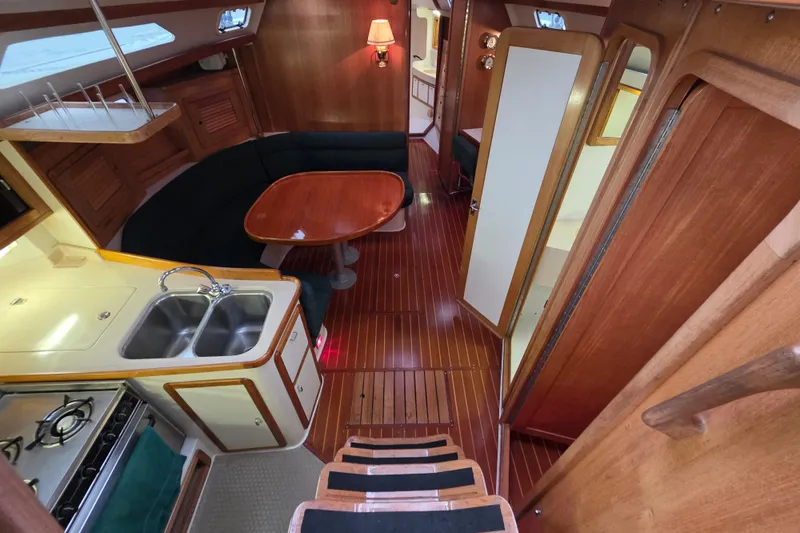 Slide: The Image of Interior of 1998 Catalina 42 MkII sailboat with kitchen and dining area. - 4