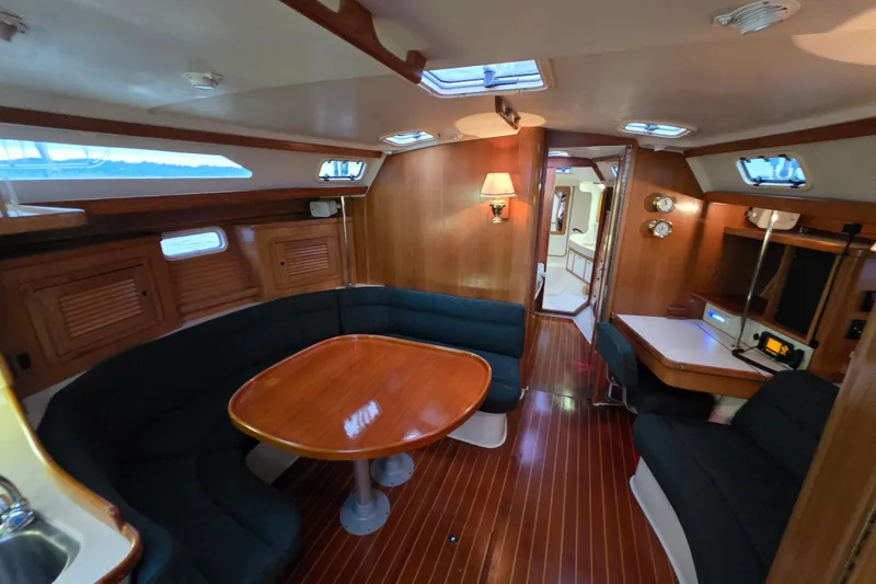 Slide: The Image of Interior of 1998 Catalina 42 MkII sailboat with wooden furnishings and cozy seating area. - 5