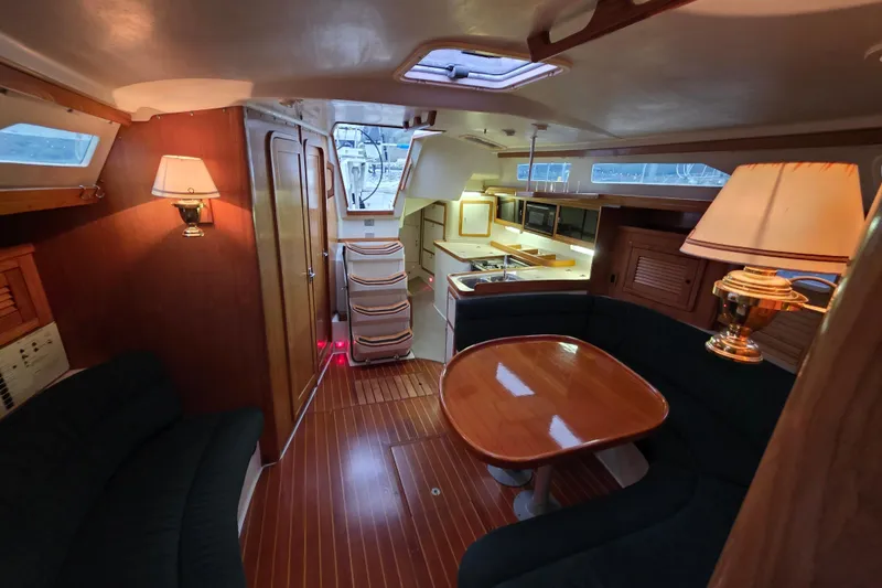 Slide: The Image of Interior of 1998 Catalina 42 MkII yacht with cozy seating and elegant wooden finishes. - 6