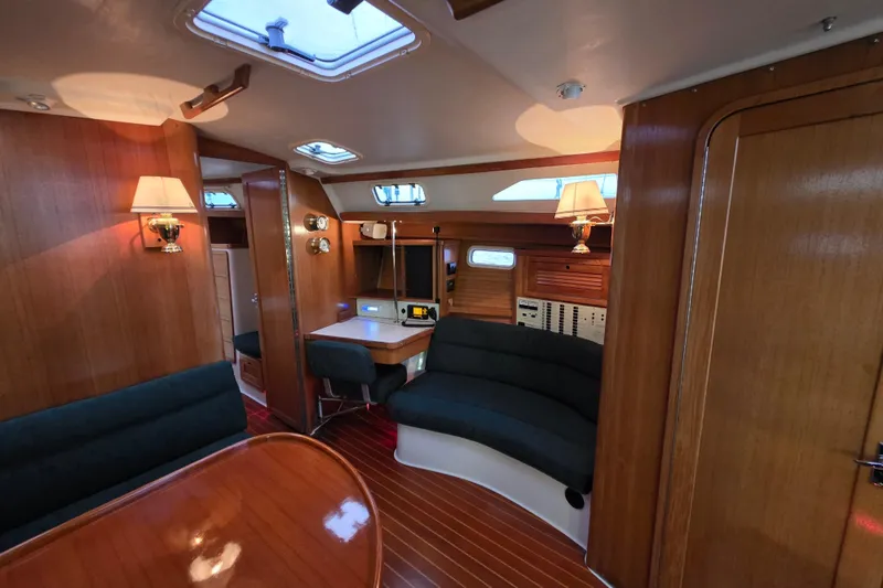 Slide: The Image of Interior of a 1998 Catalina 42 MkII sailboat with wood paneling and seating area. - 7