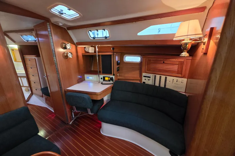 Slide: The Image of Interior of a 1998 Catalina 42 MkII sailboat with wood paneling and cozy seating. - 8