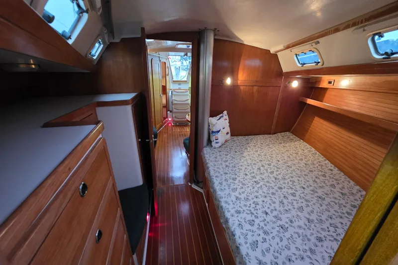 Slide: The Image of Cozy interior of 1998 Catalina 42 MkII sailboat with wooden cabinetry and comfortable sleeping area. - 9