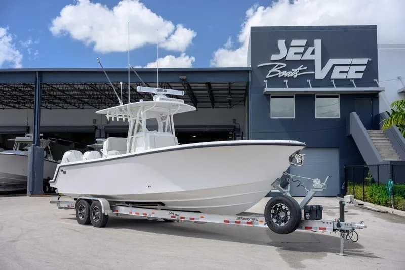 The Image of 2025 SeaVee 320B boat on trailer outside SeaVee Boats facility. - 1
