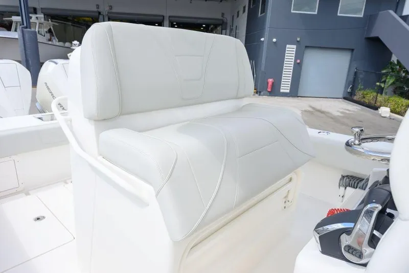 Slide: The Image of 2025 SeaVee 320B boat with white cushioned seating and modern controls. - 10